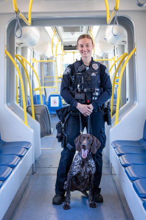 Officer in transit train with K9.
