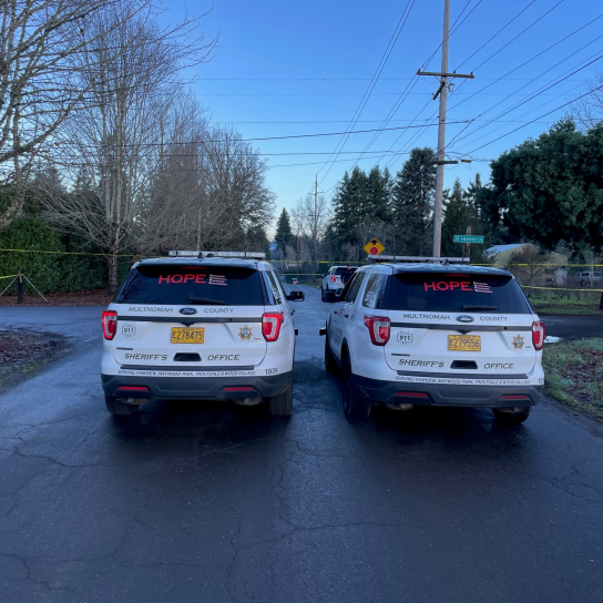 Two patrol cars parked on road in rural Multnomah County.