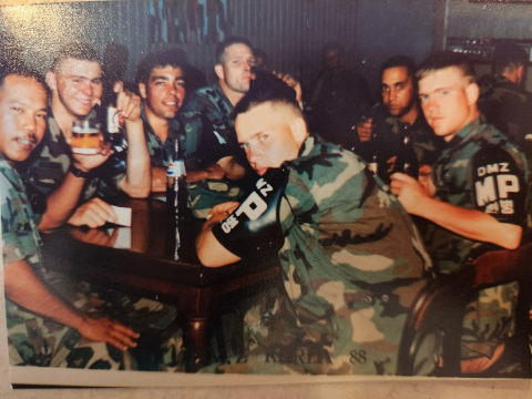 Charly sits with fellow military policemen.